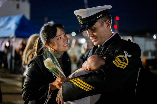 A Sailor assigned to Arleigh Burke-class guided-missile destroyer USS John Finn (DDG 113) meets his family on the pier at Commander Fleet Activities Yokosuka following a scheduled patrol in the Indo-Pacific, Nov. 3, 2025.