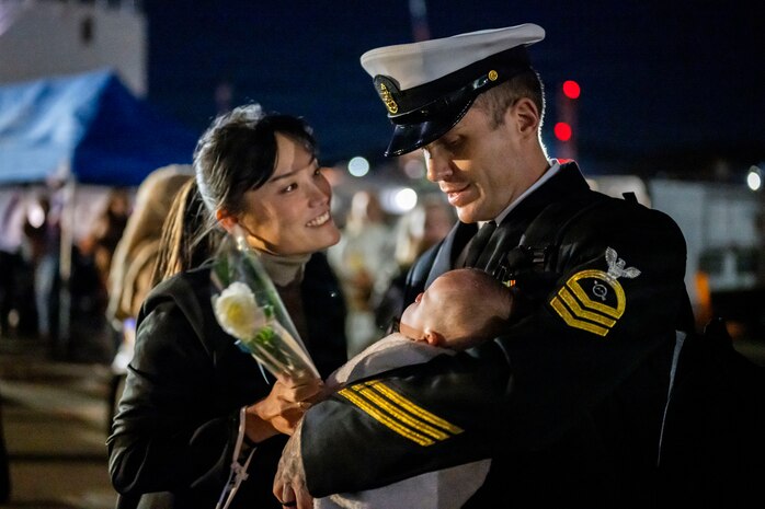 A Sailor assigned to Arleigh Burke-class guided-missile destroyer USS John Finn (DDG 113) meets his family on the pier at Commander Fleet Activities Yokosuka following a scheduled patrol in the Indo-Pacific, Nov. 3, 2025.