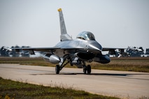 A U.S. Air Force F-16 Fighting Falcon  assigned to the 35th Fighter Squadron taxis in  during Freedom Flag 25-2 at Kunsan Air  Base, Republic of Korea, Nov. 4, 2025. FF  25-2 is a routine event conducted to maintain  readiness and enhance joint and bilateral  partnerships.