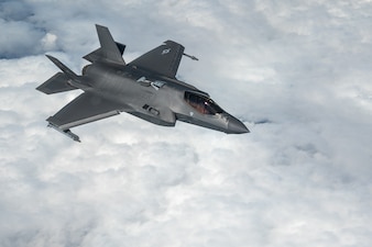 A U.S. Air Force F-35 Lightning II flies over clouds.