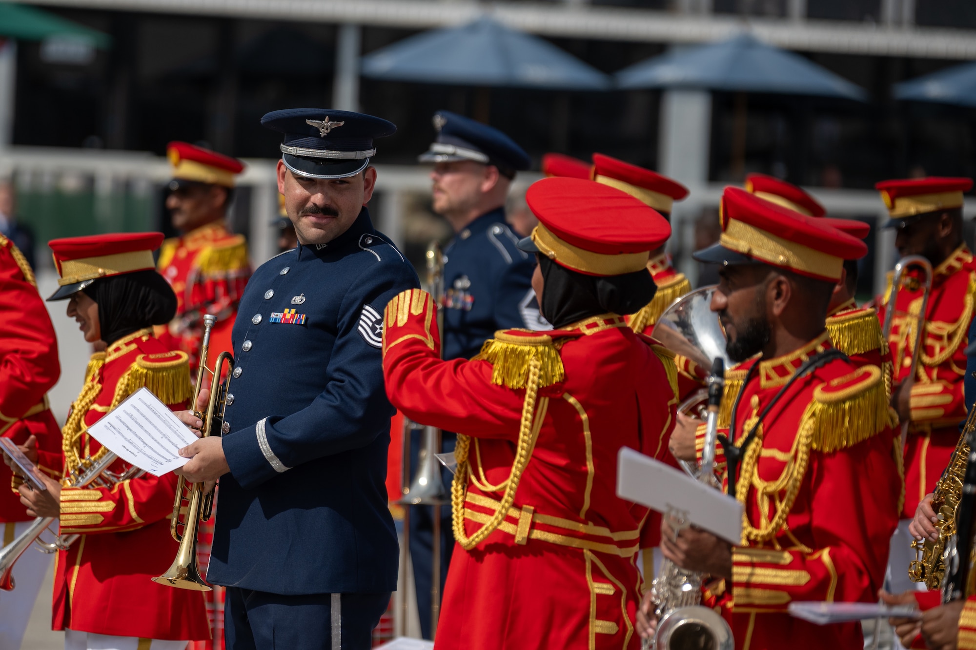 People in military uniforms play musical instruments