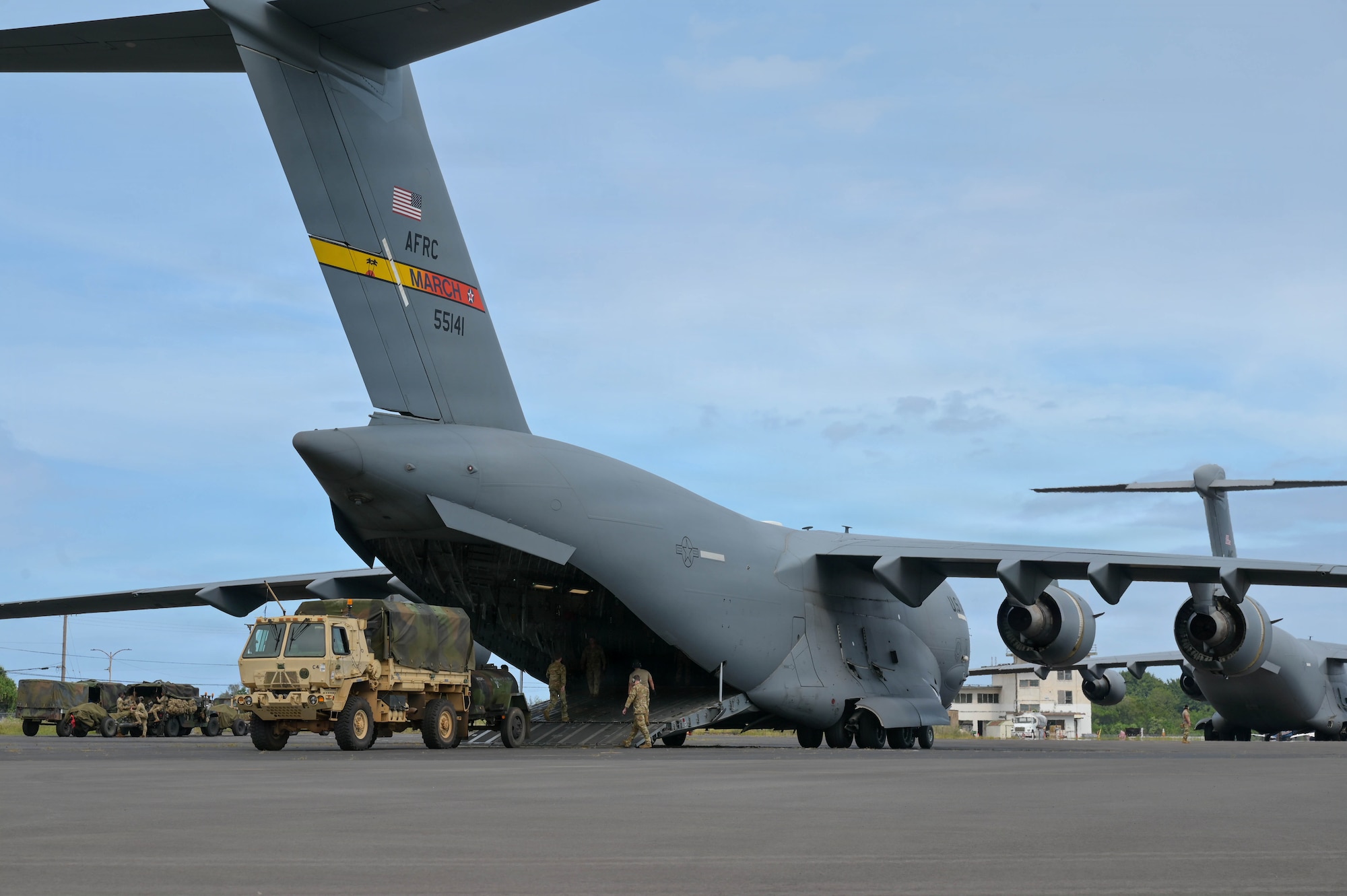 U.S. Army vehicles unloaded from a U.S. Air Force aircraft.