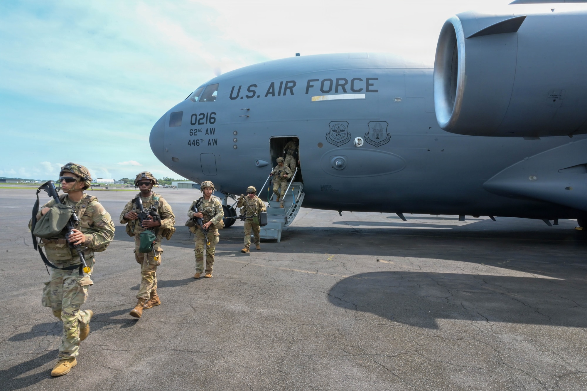 Soldiers exiting a U.S. Air Force aircraft.