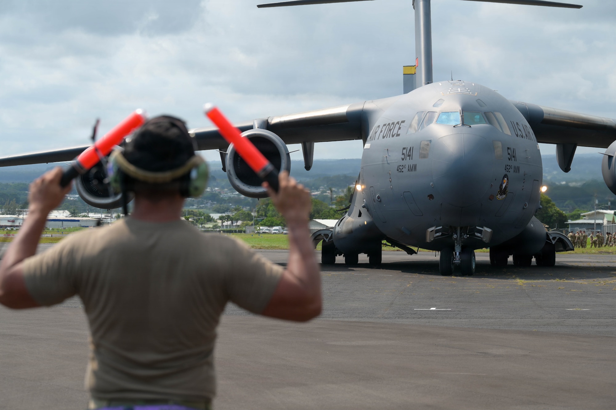An Airman guides a U.S. Air Force aircraft on the flightline.