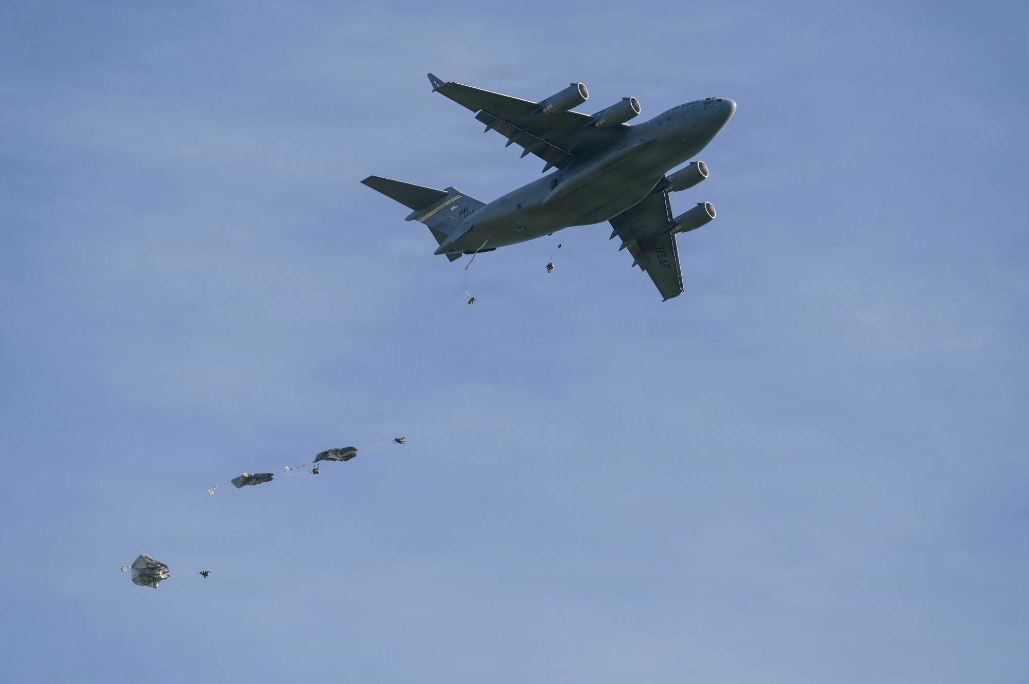 A U.S. Air Force aircraft delivers parachuted soldiers.