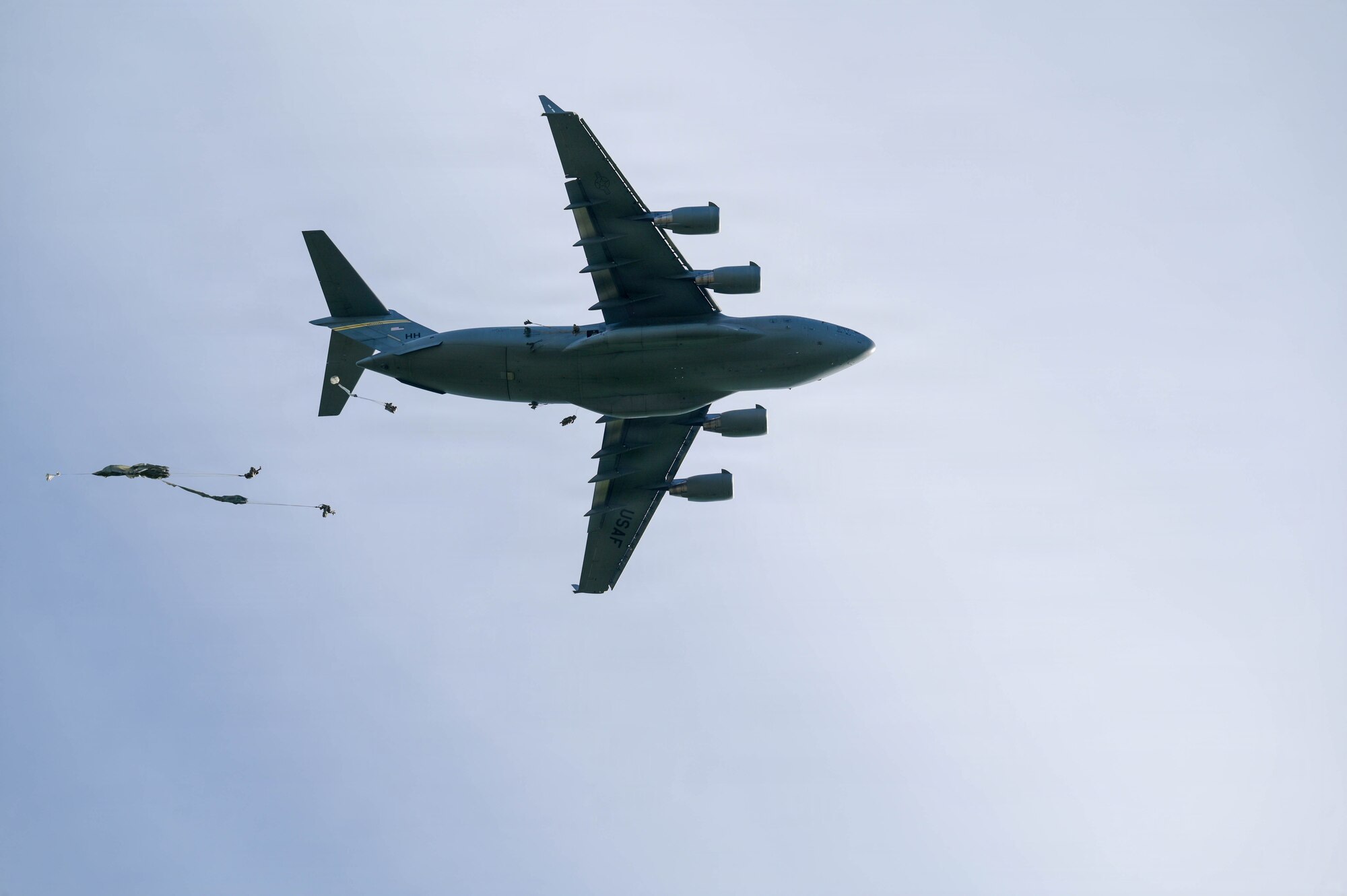 A U.S. Air Force aircraft delivers parachuted soldiers.