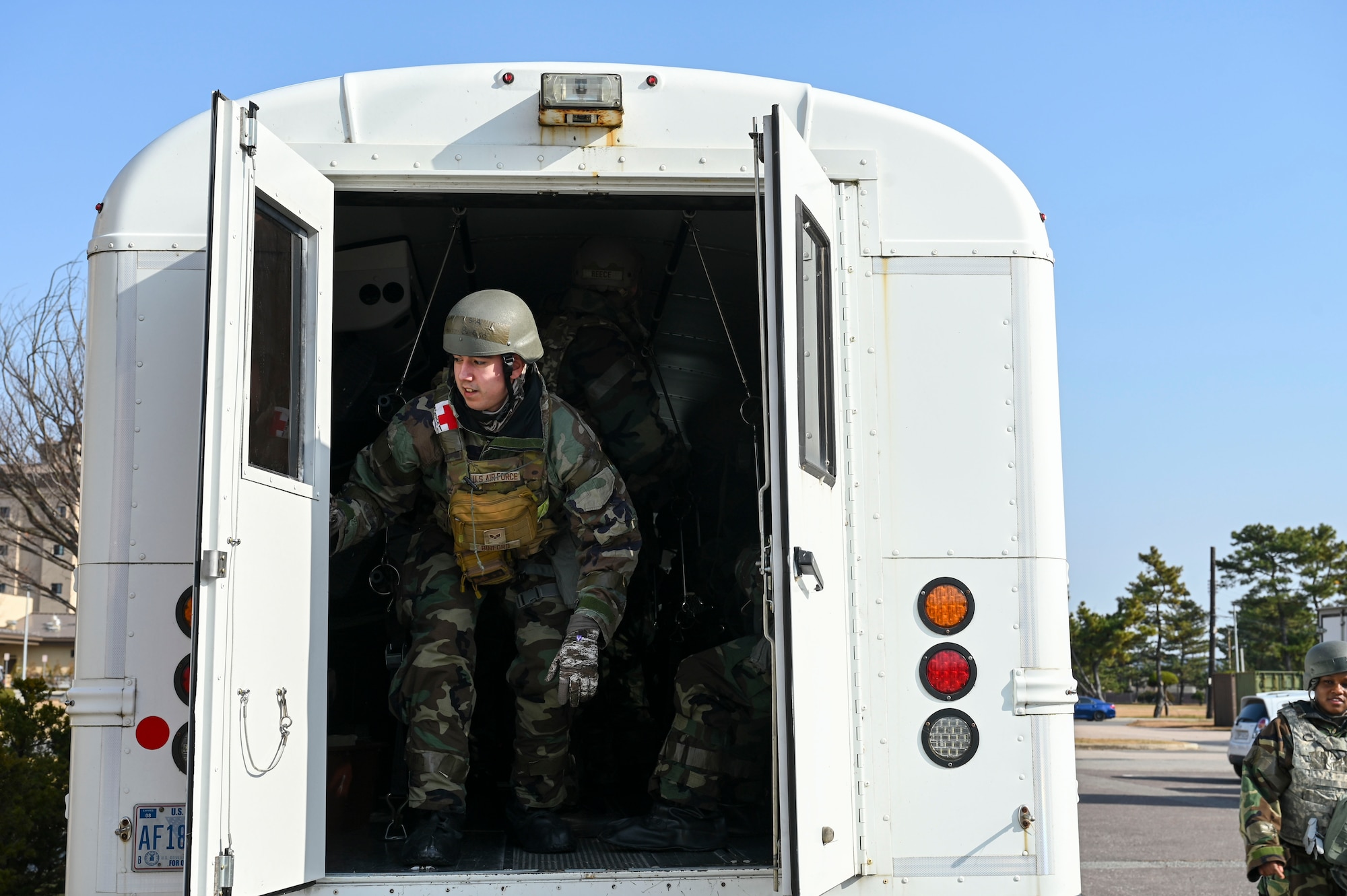 A man opens a bus door.
