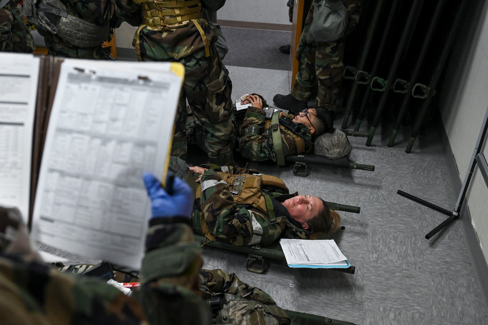 A person helps a patient on a stretcher.