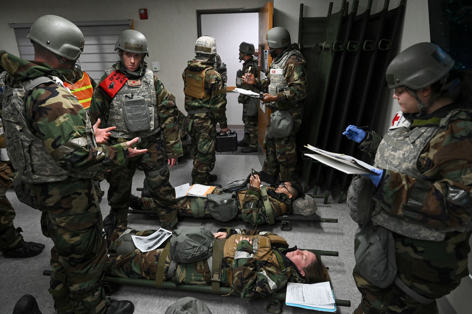 A group of people gather around patients.