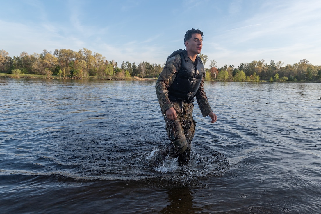 Army Reserve Best Squad competitor Pfc. Alexander Vasquez-Cortes, 335th Signal Command, emerges from the water after an engineer swim event at Fort McCoy Wisconsin, May 12, 2025. Three Soldiers from around the nation compete in the 2025 Army Reserve BMC, an annual competition that brings together the best Soldiers from across the U.S. Army Reserve to earn the title of “Best Medic” among their peers. (U.S. Army Reserve photo by Calvin Reimold)