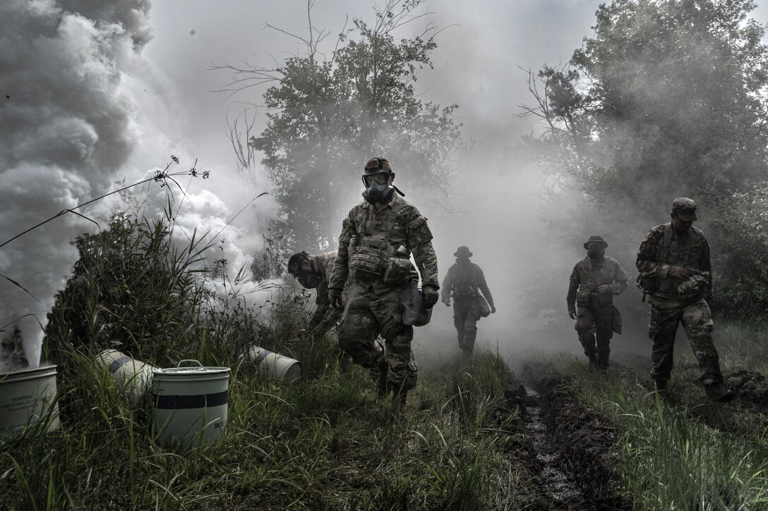 U.S. Army Reserve Soldiers from the 351st Ordnance Company provide smoke coverage as engineers construct a multi-role bridge to cross a wet gap at Global Strike 2025 during the Combat Support Training Exercise (CSTX) at Fort McCoy, Wisconsin, Aug. 11. The CSTX prepares Army Reserve units for deployment by providing realistic, externally evaluated, and collective training scenarios. (U.S. Army Reserve photo by Staff Sgt. Philip Ribas)