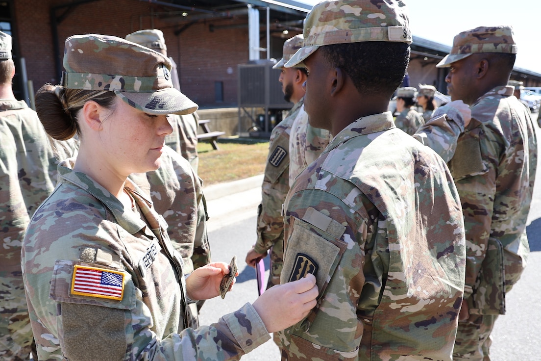 Soldier receives unit patch during ceremony