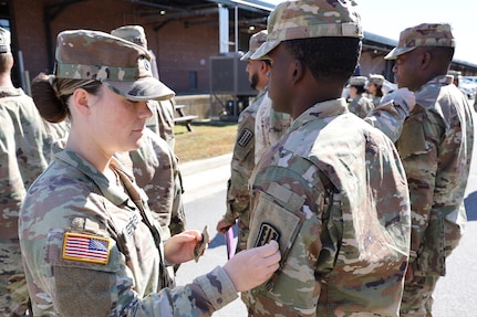 Soldier receives unit patch during ceremony