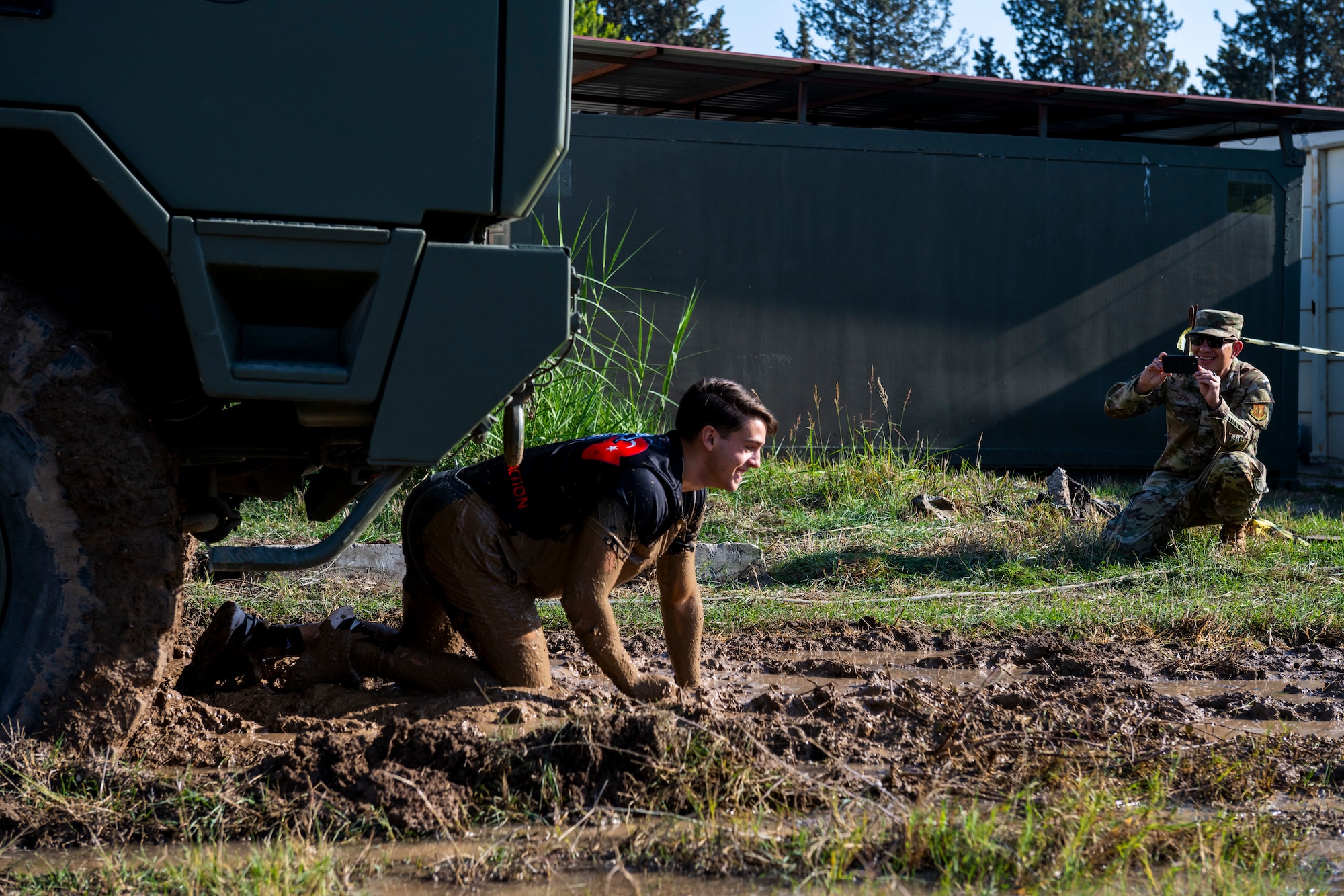 A U.S.service member crawls through the mud