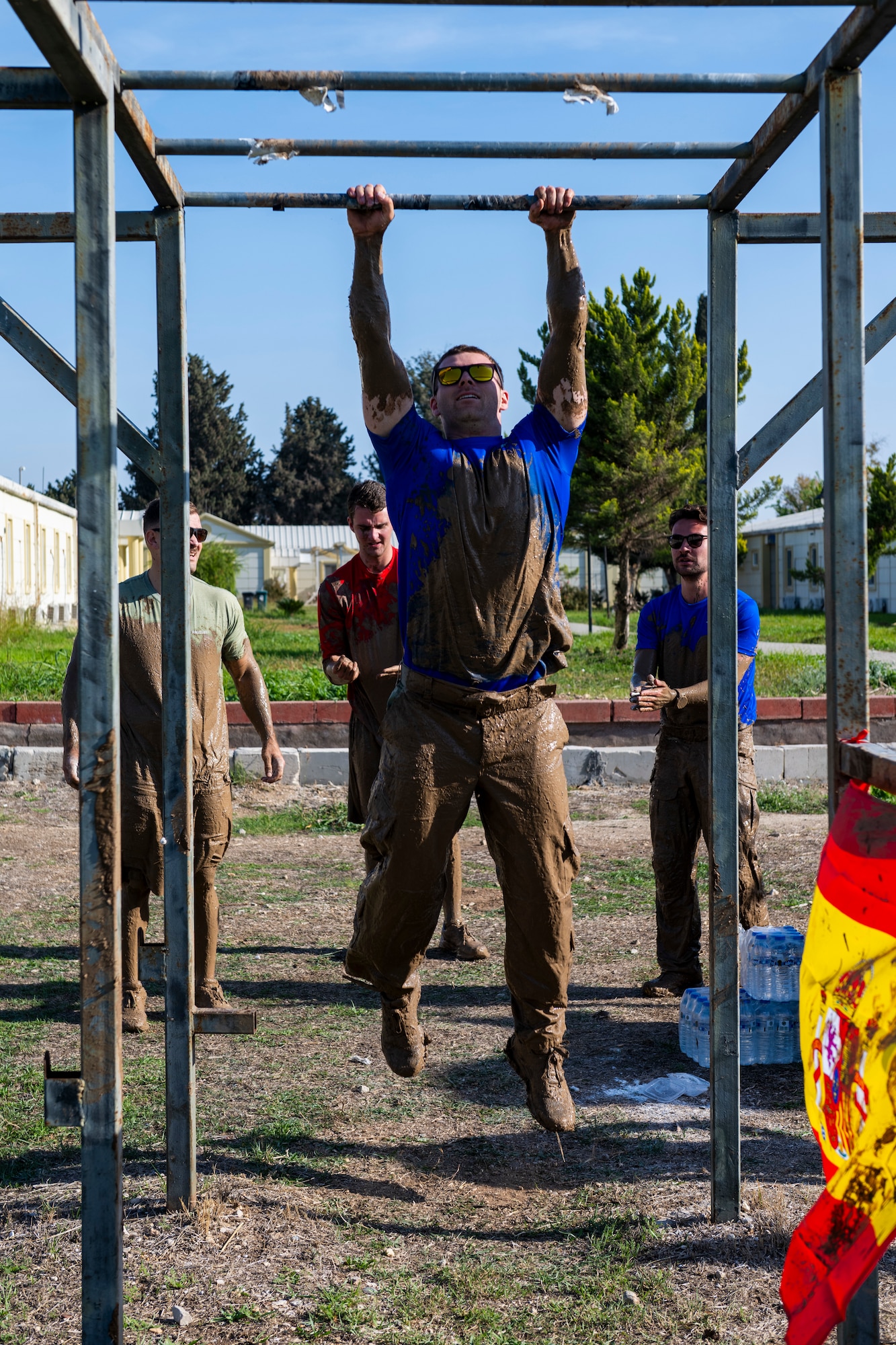 A U.S. service member swings across the monkey bars