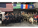 Members of the New York Police Department's Emergency Services Unit and Airmen from the New York Air National Guard's 103rd Rescue Squadron, assigned to the 106th Rescue Wing, pose for a group photo at Floyd Bennett Field, Brooklyn, N.Y., Oct. 23, 2025. The units partnered for a two-day exercise involving simulated hostage rescue scenarios, close-quarters combat, and medical care. Courtesy photo.
