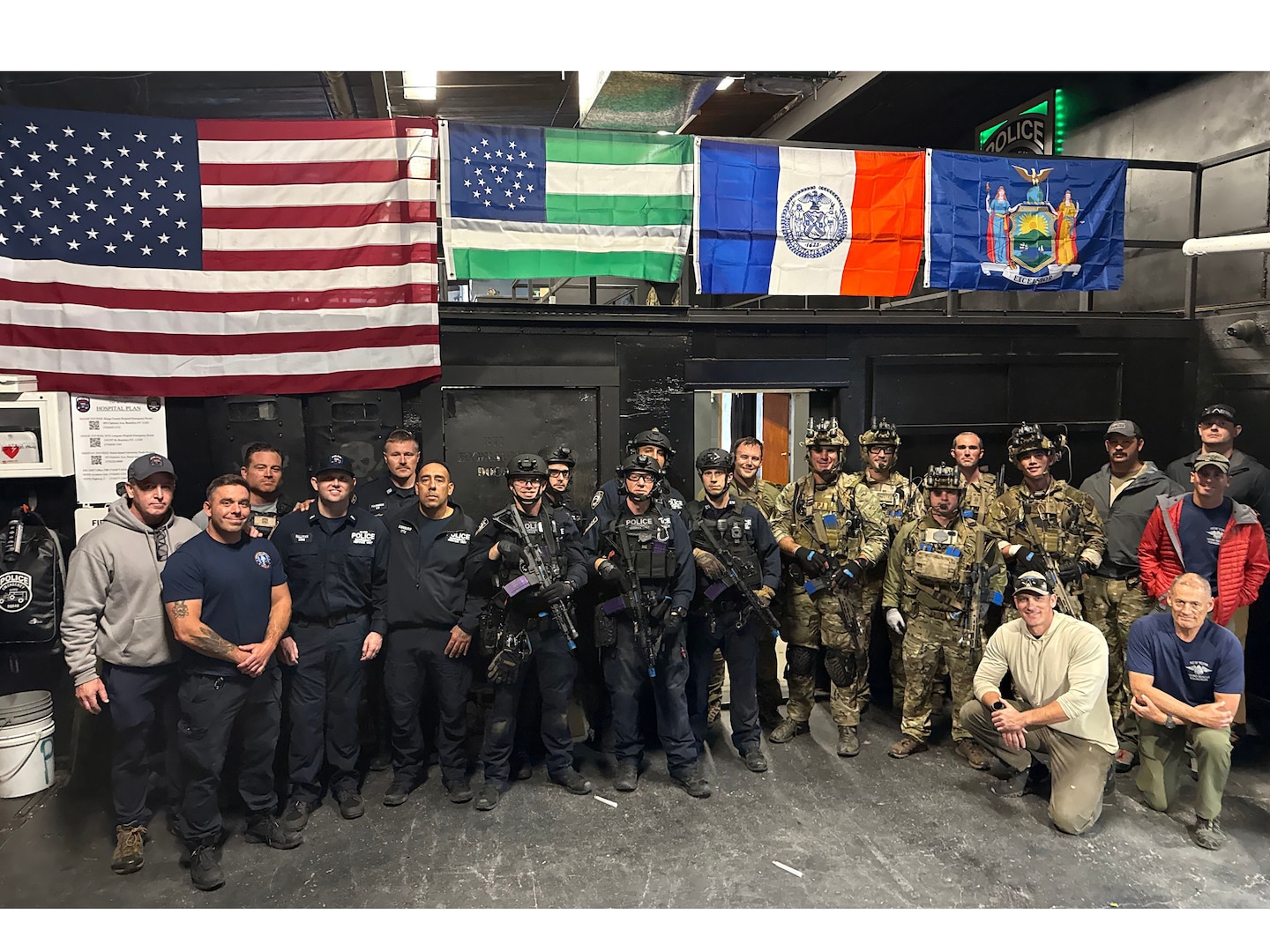 Members of the New York Police Department's Emergency Services Unit and Airmen from the New York Air National Guard's 103rd Rescue Squadron, assigned to the 106th Rescue Wing, pose for a group photo at Floyd Bennett Field, Brooklyn, N.Y., Oct. 23, 2025.