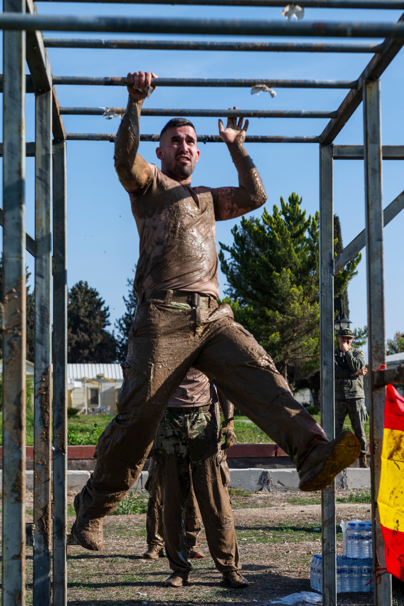 A Polish service member climbs monkey bars