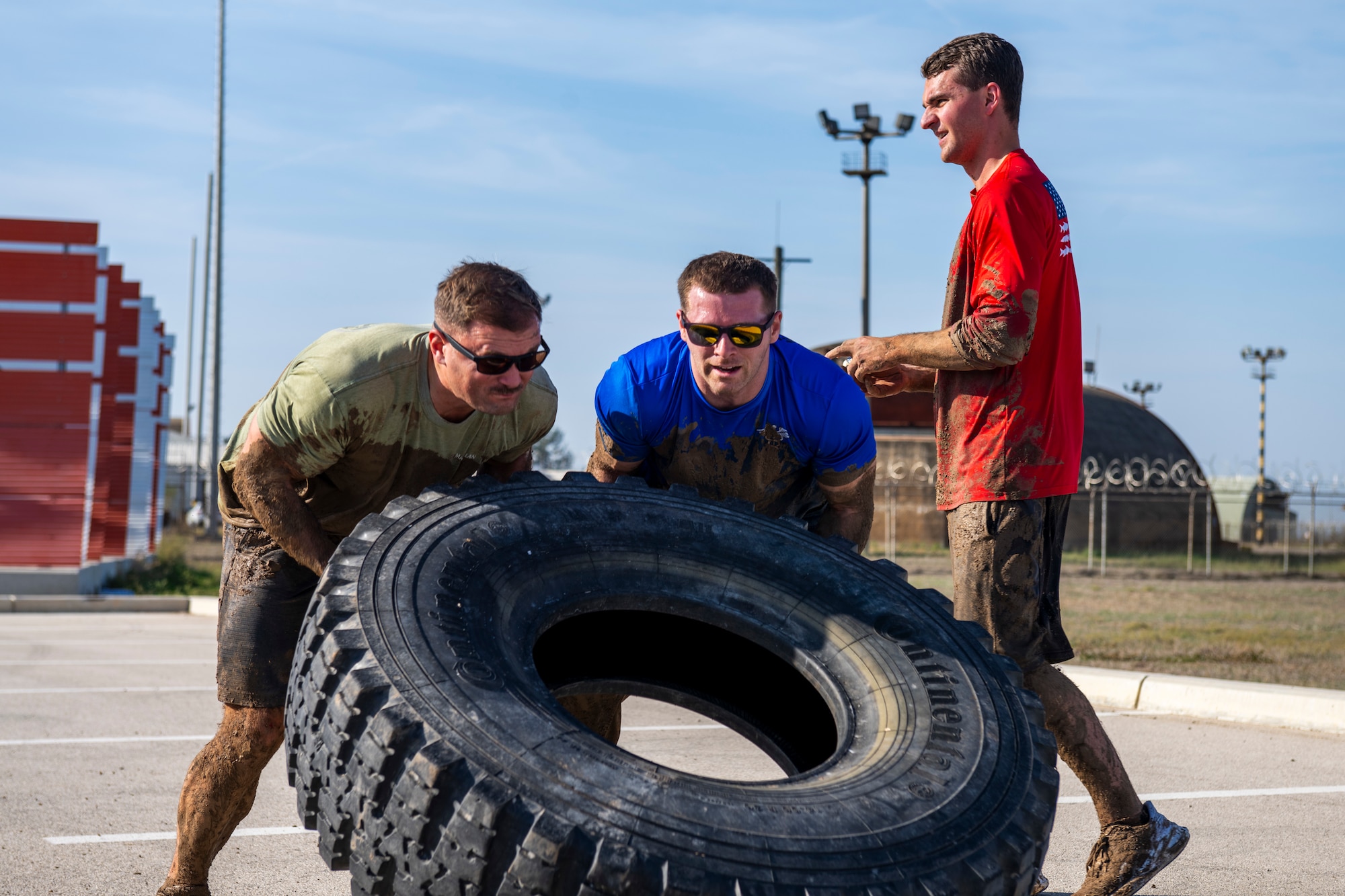 U.S. service members flip a tire
