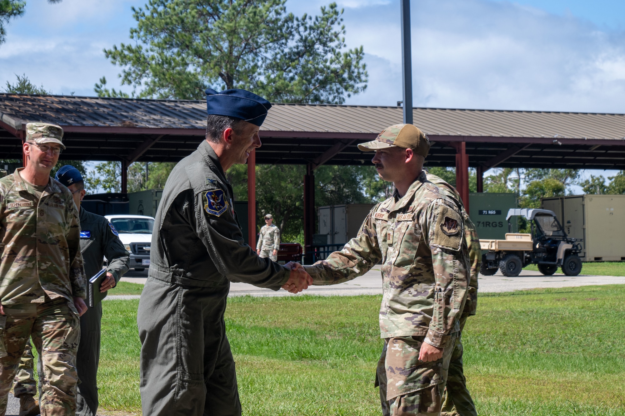 Two men shake hands.