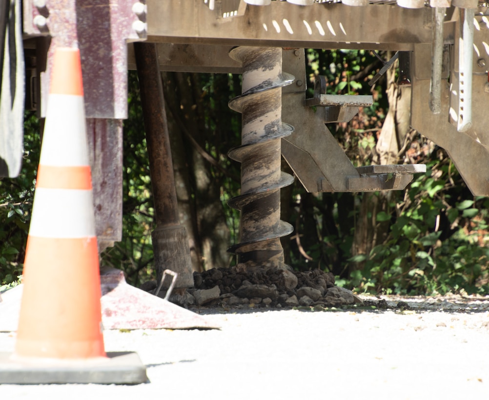 Dallas Spencer, the lead driller and crew chief with the U.S. Army Corps of Engineers' Fort Worth District's Geotechnical Branch, prepares to bore an 8-inch hole into the ground to sample the subsurface earth to determine material composition.