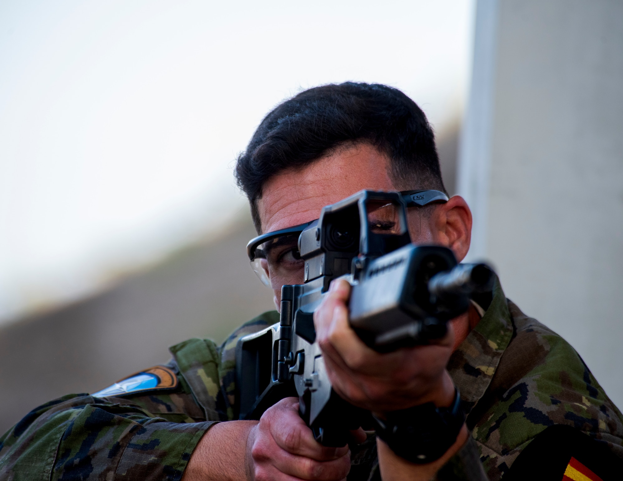 A Spanish service member demonstrates required firing positions