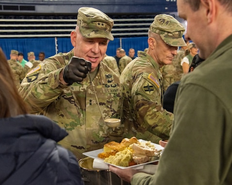 U.S. Army Maj. Gen. Dwayne Wilson, center left, adjutant general, Georgia Department of Defense, serves food to Soldiers and Airmen for a Thanksgiving celebration at the D.C. Armory in Washington, D.C., Nov. 27, 2025. About 2,400 National Guard members are supporting the D.C. Safe and Beautiful mission providing critical support to the D.C. Metropolitan Police Department in ensuring the safety of all who live, work and visit the District. (U.S. Air National Guard photo by Senior Master Sgt. Jeremy Farson)