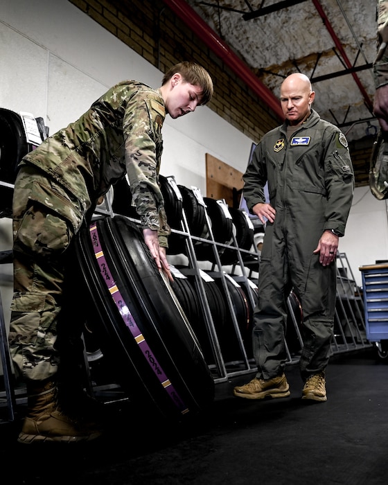 U.S. Air Force Senior Airman Mary Hall (left), 56th Aircraft Maintenance Squadron wheel and tire journeyman, briefs Brig. Gen. David Berkland (right), 56th Fighter Wing commander, on tire specifications