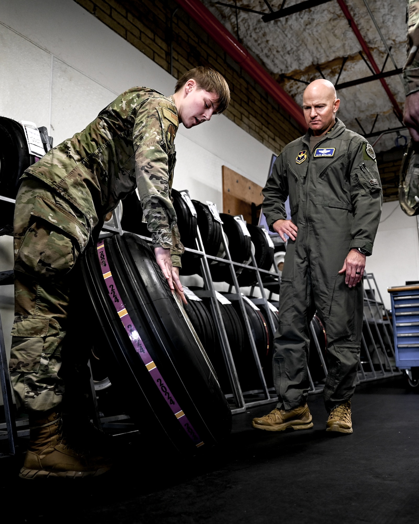 U.S. Air Force Senior Airman Mary Hall (left), 56th Aircraft Maintenance Squadron wheel and tire journeyman, briefs Brig. Gen. David Berkland (right), 56th Fighter Wing commander, on tire specifications