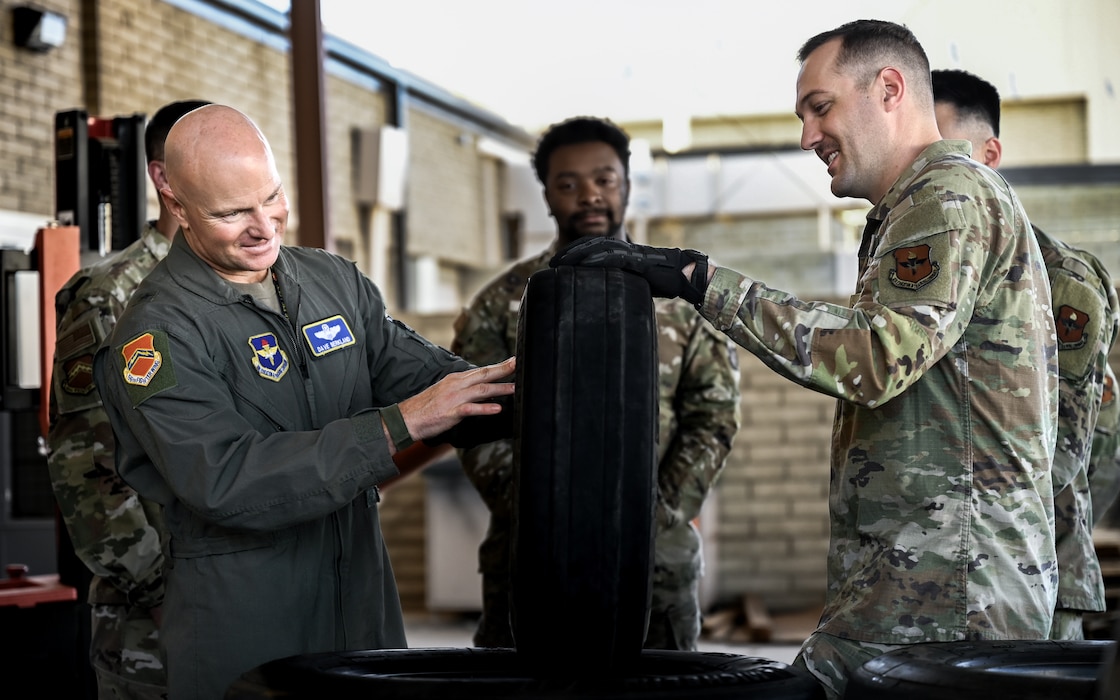 U.S. Air Force Brig. Gen. David Berkland (left), 56th Fighter Wing commander, is briefed about tire aspects by Staff Sgt. Izaak Brown (right), 56th Aircraft Maintenance Squadron wheel and tire craftsman