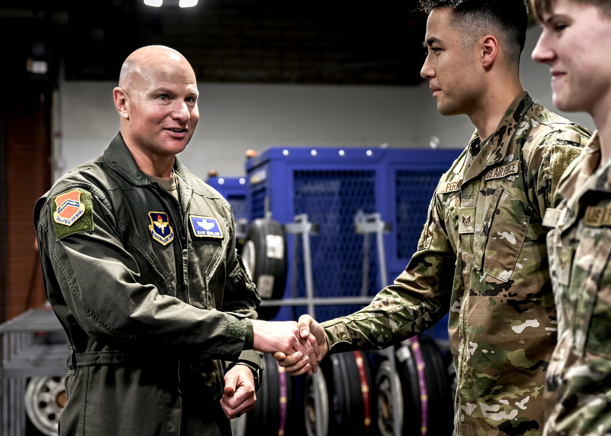 U.S. Air Force Brig. Gen. David Berkland, 56th Fighter Wing commander, greets Airmen assigned to the 56th Aircraft Maintenance Squadron