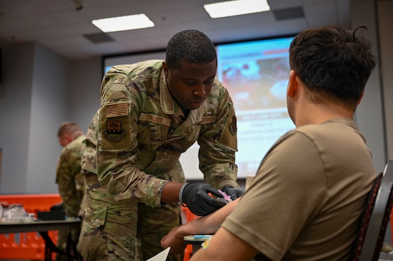U.S. Air Force Tech. Sgt. Terrell Truitt, an aerospace medical specialist assigned to the 165th Medical Group, 165th Airlift Wing (AW), Georgia Air National Guard, draws blood from an Airman during the annual 165 AW Periodic Health Assessment (PHA) at the Savannah Air National Guard Base, Georgia, Nov. 1, 2025. This year’s PHA was a streamlined two-day medical readiness event that provided immunizations, dental exams, health assessments, and more to approximately 880 service members. (U.S. Air National Guard photo by Senior Airman Selena Acosta)