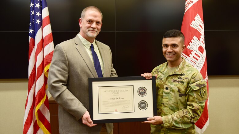 Lt. Col. Guillermo Guandique, U.S. Army Corps of Engineers Nashville District commander, presents Retiree Jeff Ross the 2025 Nashville District Distinguished Civilian Award during a ceremony Dec. 1, 2025, at the headquarters in Nashville, Tennessee. (USACE Photo by Lee Roberts)