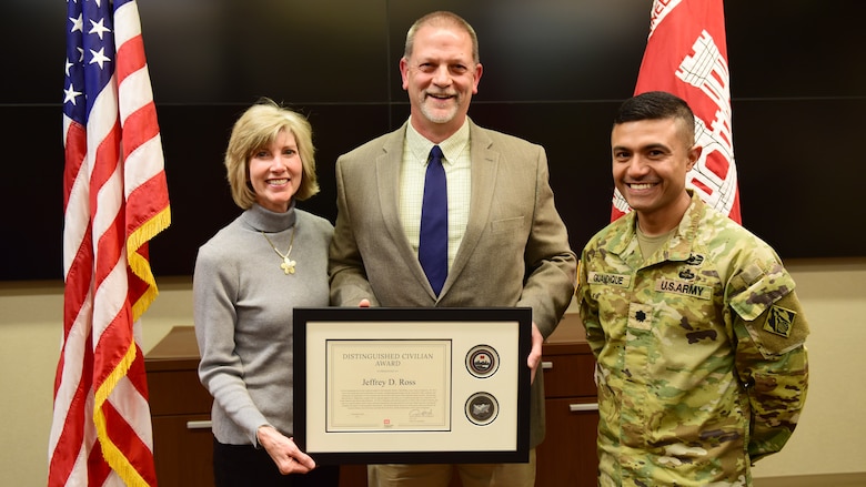 Lt. Col. Guillermo Guandique, U.S. Army Corps of Engineers Nashville District commander; poses Dec. 1, 2025, with Retiree Jeff Ross and his wife Jennifer after unveiling a nameplate honoring Ross as a recipient of the 2025 Nashville District Distinguished Civilian Award at the headquarters in Nashville, Tennessee. (USACE Photo by Lee Roberts)