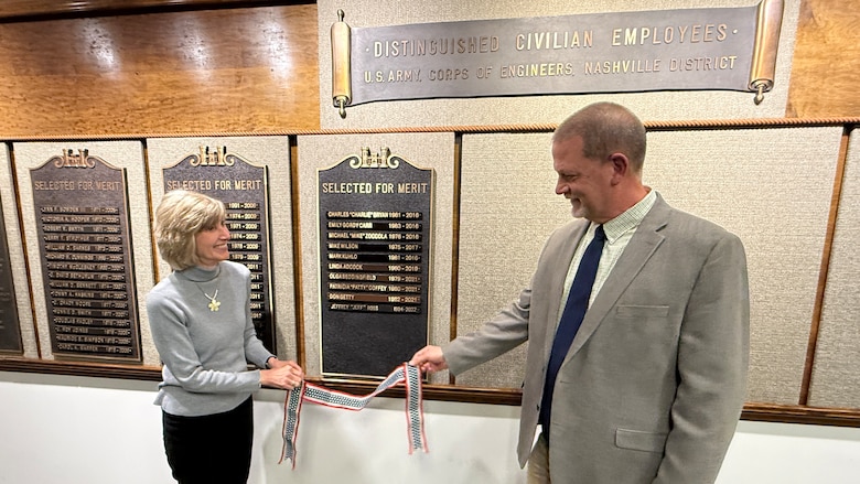 Retiree Jeff Ross and his wife Jennifer unveil his nameplate during a ceremony Dec. 1, 2025, at the U.S. Army Corps of Engineers Nashville District Headquarters recognizing exceptional achievements over the span of 38 years of federal service resulting in his selection for the 2025 Distinguished Civilian Award. (USACE Photo by Lee Roberts)