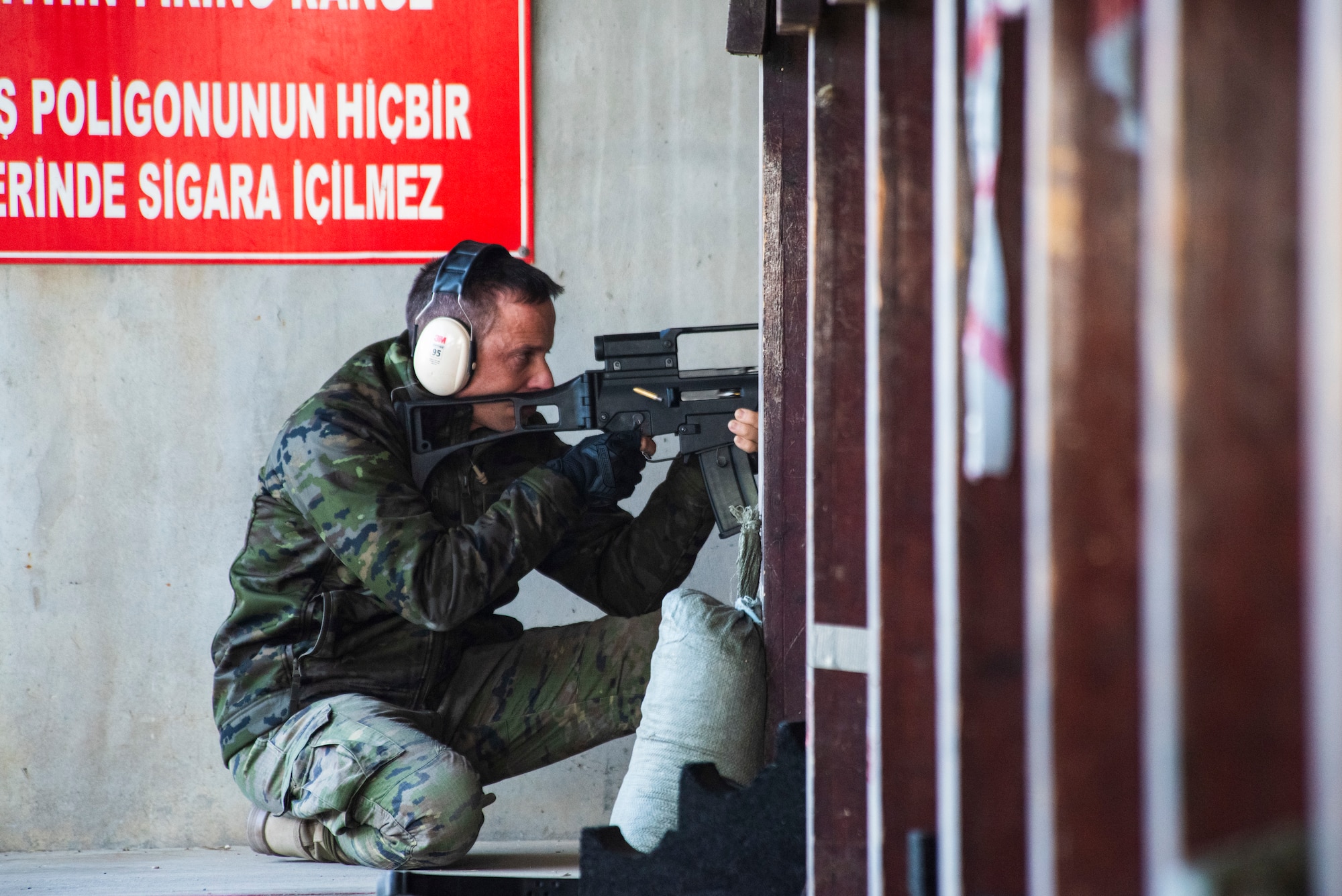 A Spanish service member demonstrates a firing position
