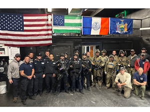 Members of the New York Police Department's Emergency Services Unit and Airmen from the New York Air National Guard's 103rd Rescue Squadron, assigned to the 106th Rescue Wing, pose for a group photo at Floyd Bennett Field, Brooklyn, N.Y., Oct. 23, 2025.