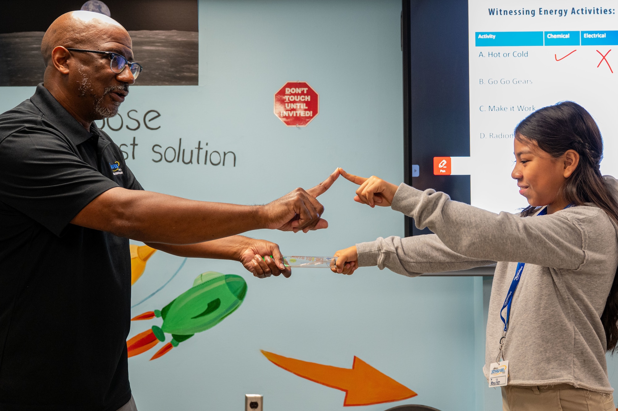 Darrin Roberson, STARBASE Maxwell instructor, assists a student during a lesson at Maxwell Air Force Base, Alabama, Oct. 8, 2025.