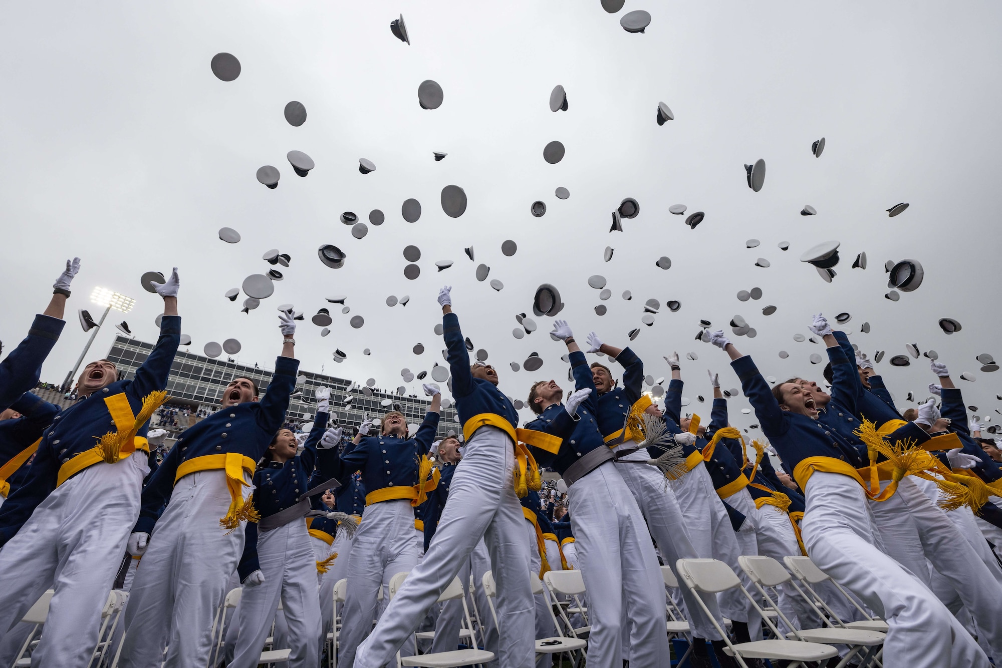 Photo of cadets tossing their caps in the air after graduation