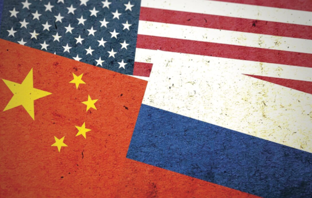 Overlapping flags of the United States, China, and Russia.