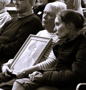 Janet Ulbrich holds a photograph of her uncle, U.S. Army Sgt. Harold W. TeVoert, with her daughter, Karen Ulbrich and Bloomington (IL) Mayor Dan Brady at American Gold Star Families’ Fallen Heroes Tree of Honor Tree Lighting Ceremony.