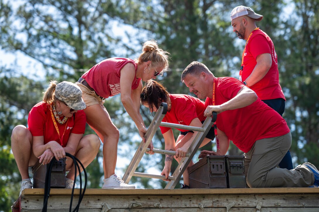 Educators from Recruiting Station Lansing, Michigan negotiate an obstacle course during Educators Workshop at Marine Corps Recruit Depot Parris Island, South Carolina, May 1, 2025. Participants of the workshop visited the depot for a four-day period to observe recruit training and gain a better understanding about the transformation from recruits to United States Marines. (U.S. Marine Corps photo by Sgt. Israel Sheber)
