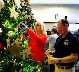 U.S. Army Survivor Outreach Services Coordinator Michelle Rutherford and Darin Funk, the incoming executive director of American Gold Star Families, Inc., affix ornaments to the tree.