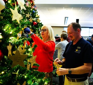 U.S. Army Survivor Outreach Services Coordinator Michelle Rutherford and Darin Funk, the incoming executive director of American Gold Star Families, Inc., affix ornaments to the tree.