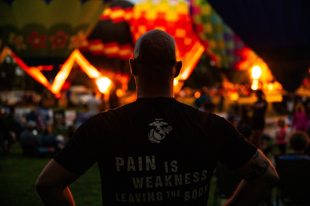 U.S. Marine Corps Staff Sergeant Todd Israel, a recruiter with Recruiting Station Lansing, 4th Marine Corps District, observes a hot air balloon demonstration during the Jackson Hot Air Balloon Jubilee at Jackson, Michigan, on July 18, 2025. The Marines attended the event to connect with the community and educate them about Marine Corps opportunities. Israel is a native of Canton, Michigan. (U.S. Marine Corps photo by Sgt. Israel Sheber)
