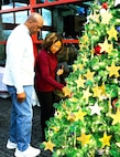 A Gold Star Family member affixes an ornament with the name of a fallen service member during the American Gold Star Families’ Fallen Heroes Tree of Honor Tree Lighting Ceremony.