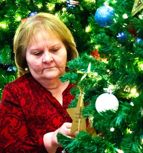 A Gold Star Family member affixes an ornament with the name of a fallen service member during the American Gold Star Families’ Fallen Heroes Tree of Honor Tree Lighting Ceremony.