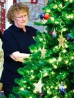 A Gold Star Family member affixes an ornament with the name of a fallen service member during the American Gold Star Families’ Fallen Heroes Tree of Honor Tree Lighting Ceremony.