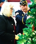 Butch and Sherry Ekstam affix an ornament on the tree with the name of their son, U.S. Army Sgt. Joseph M. Ekstam, during the American Gold Star Families’ Fallen Heroes Tree of Honor Tree Lighting Ceremony.