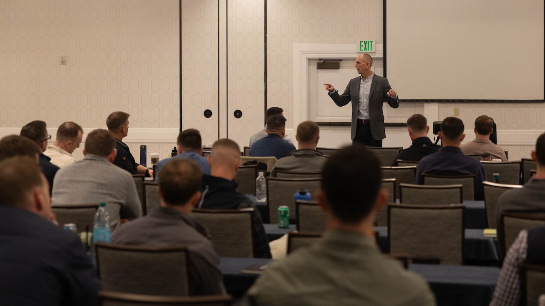 U.S. Marine Corps Brig. Gen. David K. Winnacker, commanding general, Force Headquarters Group, Marine Forces Reserve, delivers remarks during a town hall meeting with the Marine Innovation Unit in White Plains, New York, Nov. 20, 2025. During the town hall, Winnacker and Sgt. Maj. Russell D. Boley delivered remarks and answered questions from the Marine Innovation Unit. Established in 2022, the Marine Innovation Unit leverages the talent of the Marine Corps Reserve to accelerate the adoption of advanced capabilities, transform Naval Service capacity for technology employment, and retain and invest in Total Force human capital. (U.S. Marine Corps photo by Cpl. Kanoa Thomas)